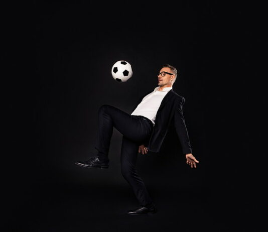 man in business suit playing football director or football