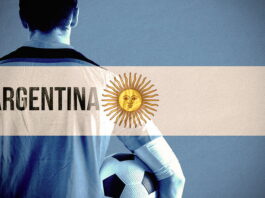 footballer holding ball argentina flag