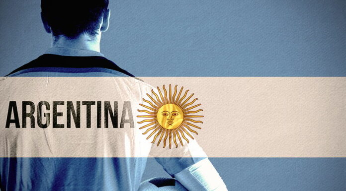 footballer holding ball argentina flag