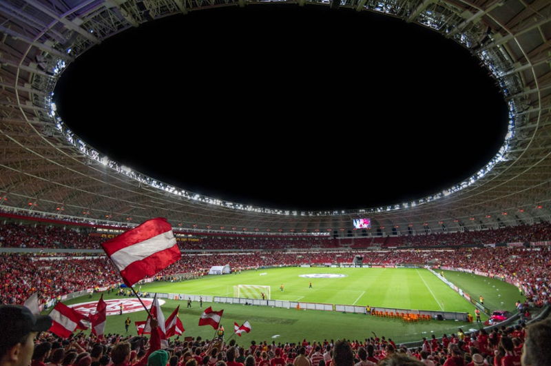 fans wave flags before big football match in large stadium