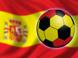 football painted with spain flag with blurred spain flag background