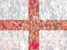 england flag in foreground over crowd in blurred background