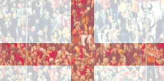 england flag in foreground over crowd in blurred background