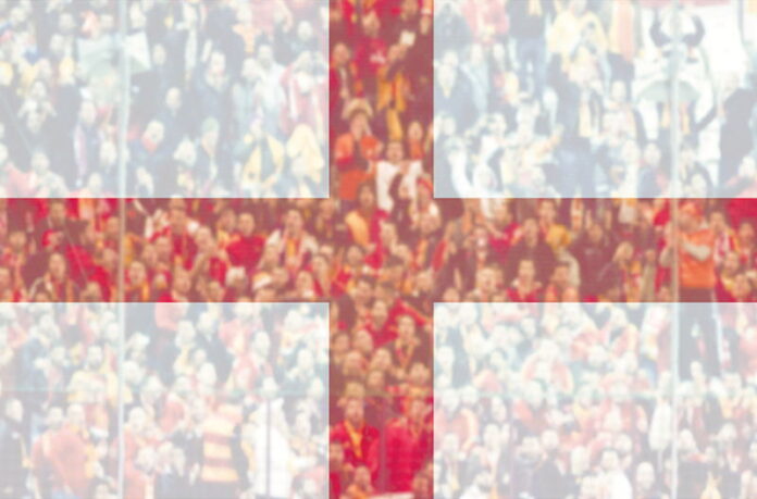 england flag in foreground over crowd in blurred background