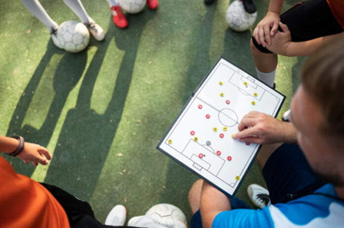 football manger going through tactics with a team