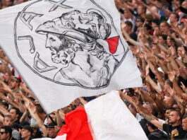 ajax flag being passed around crowd in packed stand in amsterdam arena