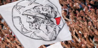 ajax flag being passed around crowd in packed stand in amsterdam arena