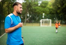coach taking football training holding whistle