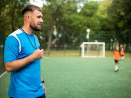 coach taking football training holding whistle