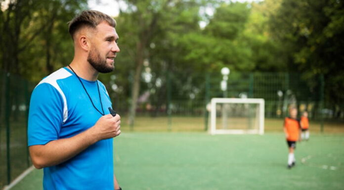 coach taking football training holding whistle