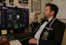 Man wearing suit to play football manager