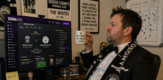 Man wearing suit to play football manager